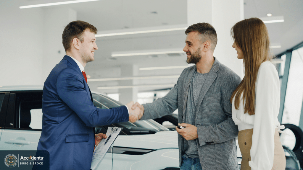 Attorney and car accident victims shaking hands after resolving a claim
