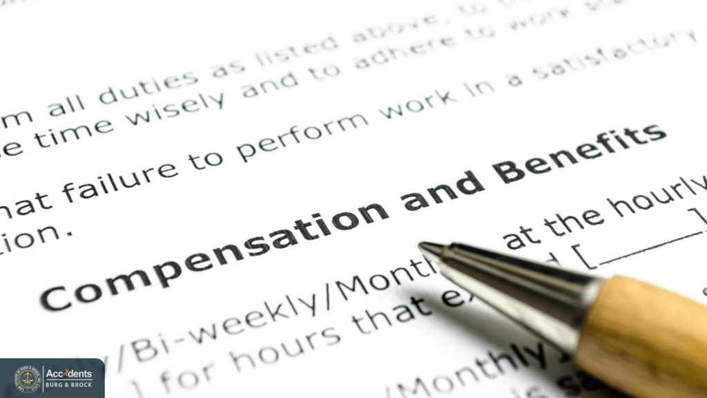 Close-up of a compensation and employee benefits form with a pen.